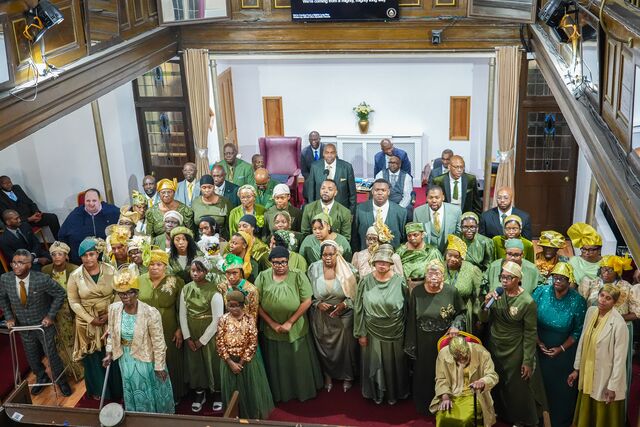 Anniversary attendees gathered for a group photograph inside the church.