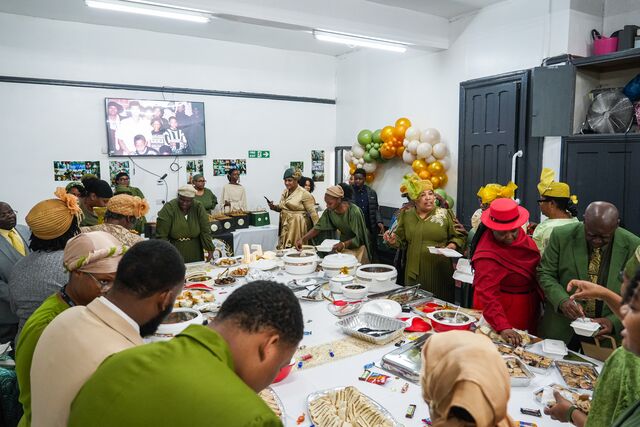 Attendees seated around tables during the anniversary meal.